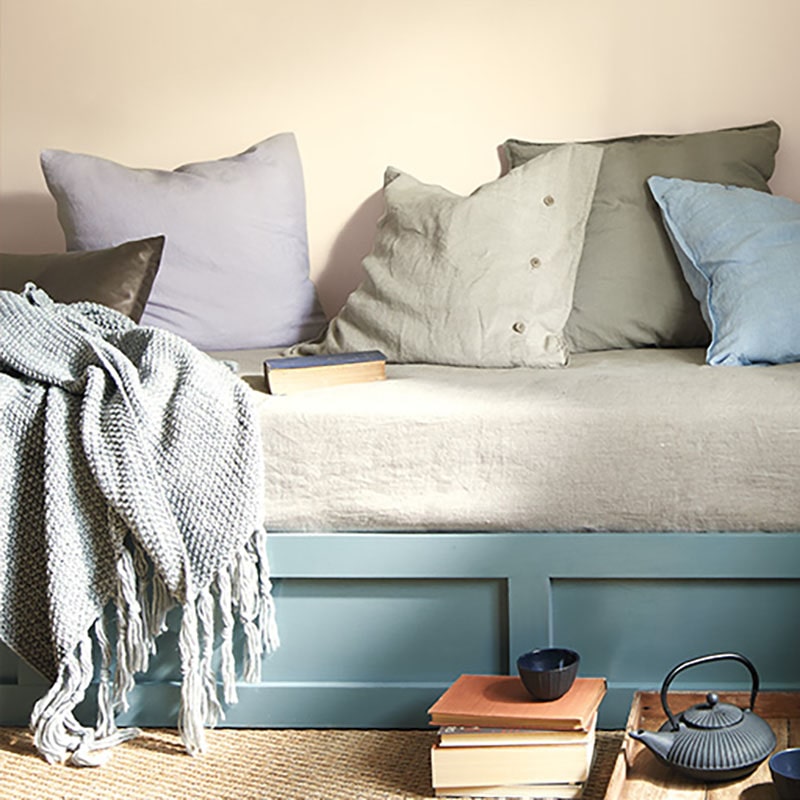 Benjamin Moore Color Trends 2021: Muslin (OC-12), With Daybed Scene, Blanket, Pillows, Books and Kettled Tea